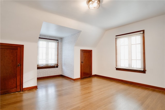 bonus room featuring light hardwood / wood-style floors and lofted ceiling