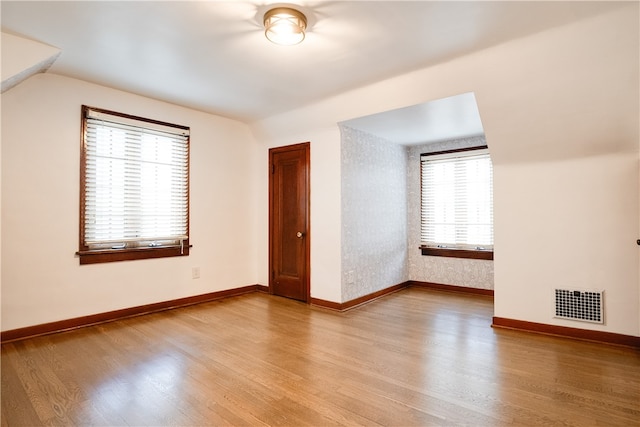 bonus room with light wood-type flooring