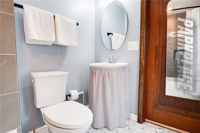 bathroom with tile patterned flooring, toilet, and sink