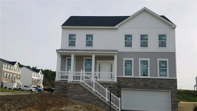 view of front of house featuring a porch and a garage