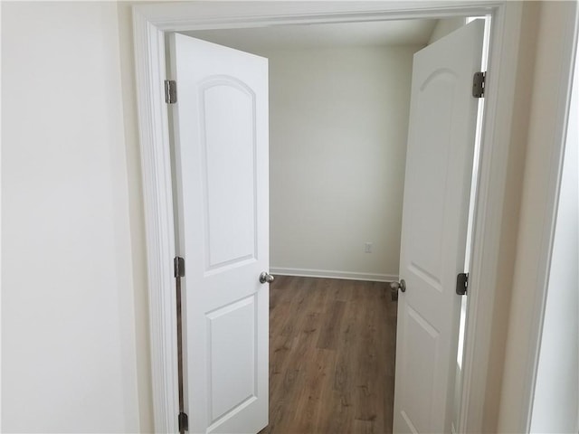 hallway with hardwood / wood-style floors