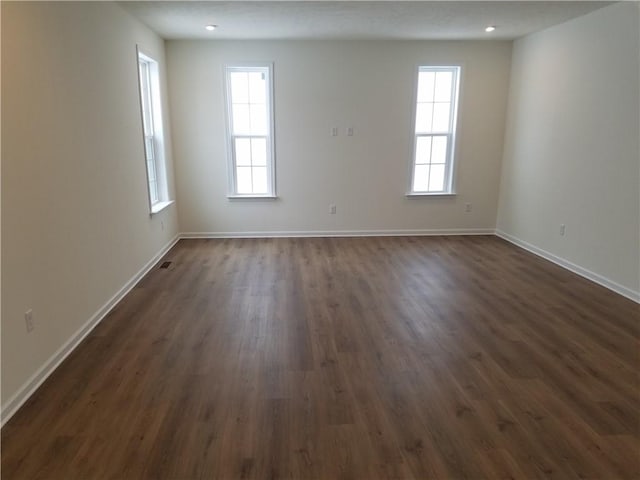 empty room featuring dark wood-type flooring