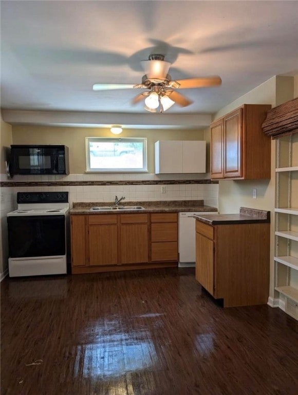 kitchen featuring dark hardwood / wood-style floors, tasteful backsplash, sink, white appliances, and ceiling fan