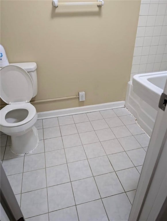 bathroom featuring toilet and tile patterned flooring