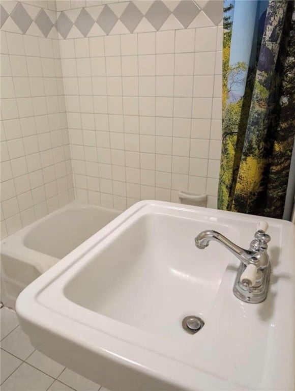 bathroom featuring toilet, sink, and tile patterned floors