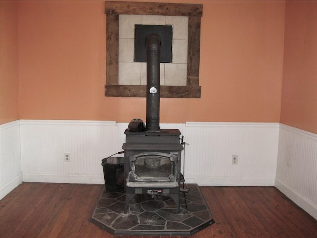 interior details with wood-type flooring and a wood stove