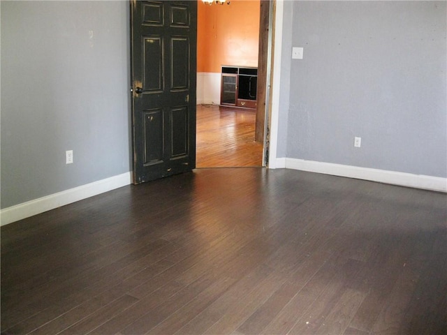 empty room featuring dark hardwood / wood-style flooring