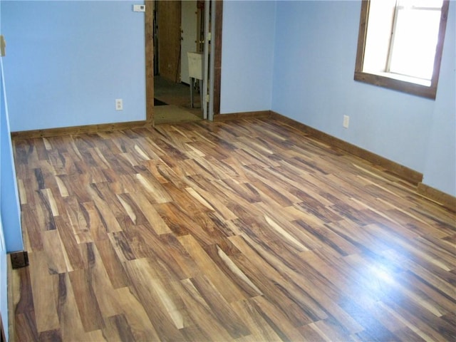 spare room featuring dark hardwood / wood-style flooring