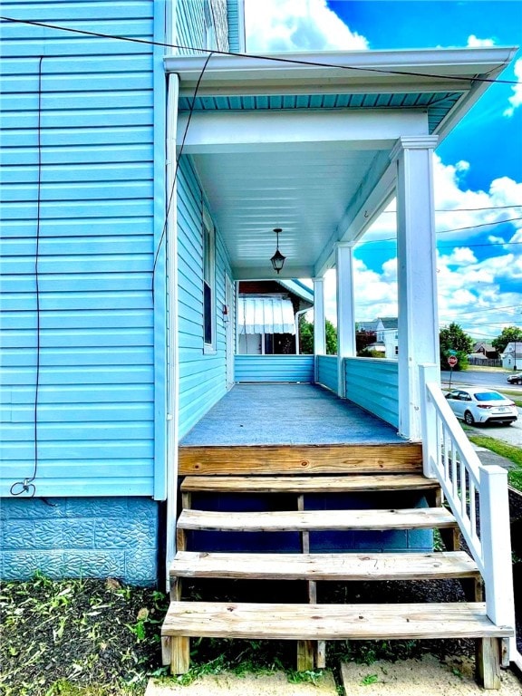 wooden terrace featuring covered porch