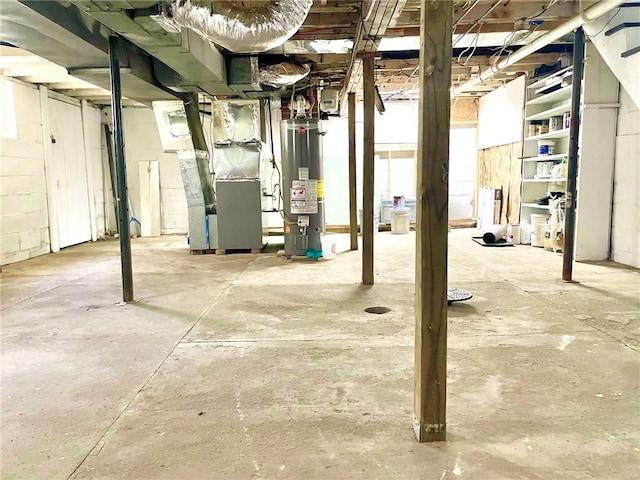 basement featuring heating unit and gas water heater