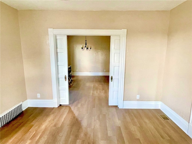 unfurnished room with hardwood / wood-style floors