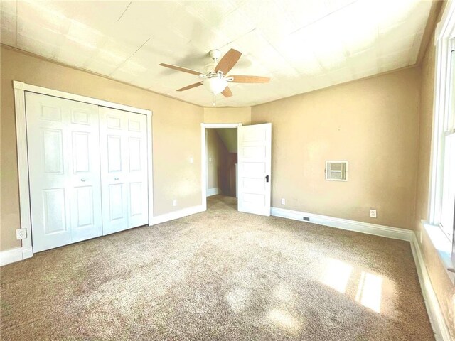 unfurnished bedroom featuring carpet floors, ceiling fan, and a closet