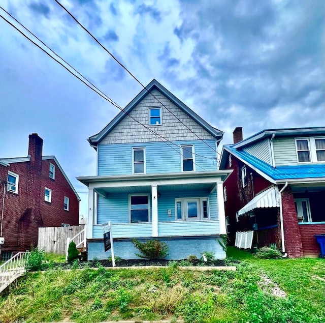 view of front of property with a porch and a front lawn