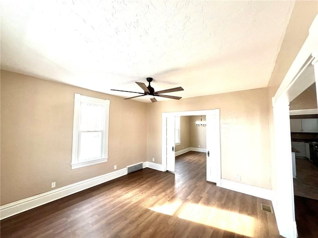 unfurnished room featuring hardwood / wood-style flooring, ceiling fan, and a textured ceiling
