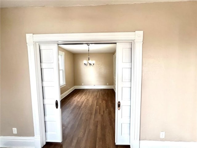 interior space with dark hardwood / wood-style flooring and a chandelier