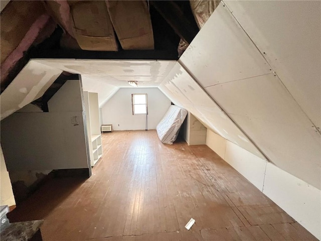additional living space with lofted ceiling and hardwood / wood-style floors