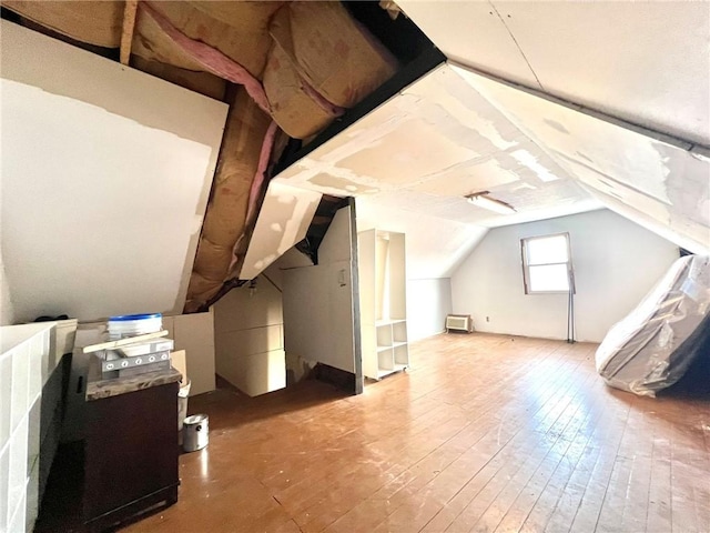 bonus room featuring lofted ceiling and wood-type flooring