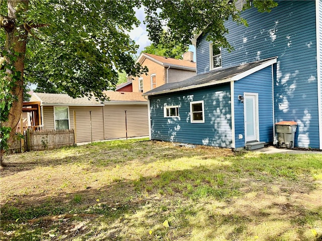 back of house with a lawn