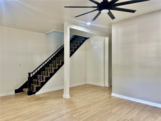 stairs featuring ceiling fan and wood-type flooring