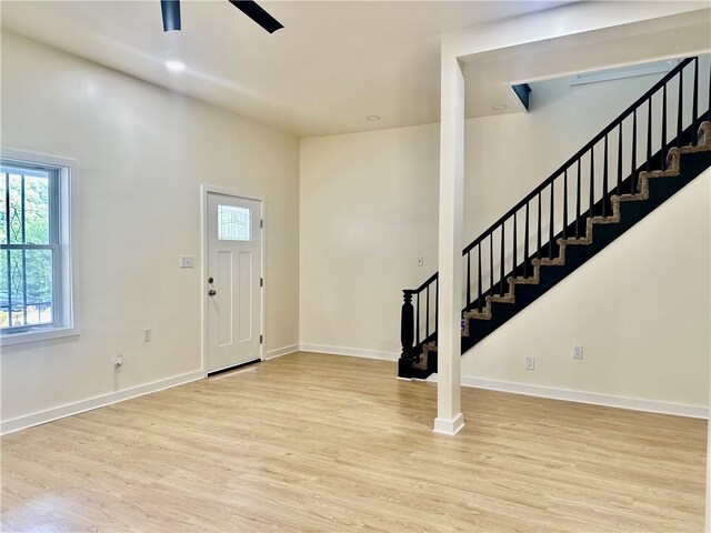 foyer with ceiling fan and light wood-type flooring