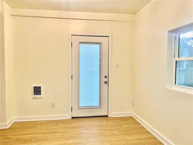 doorway with light wood-type flooring