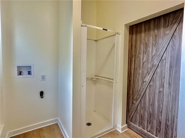 bathroom featuring a shower and hardwood / wood-style floors