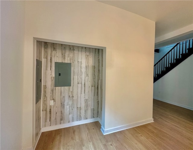 spare room with light hardwood / wood-style flooring and electric panel