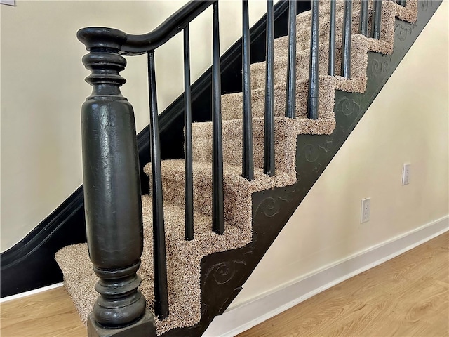 stairs featuring wood-type flooring