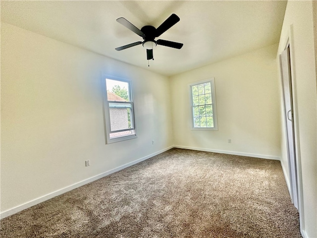 carpeted spare room with ceiling fan