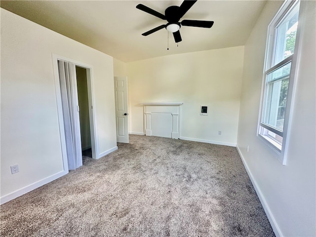 unfurnished room with light carpet and ceiling fan