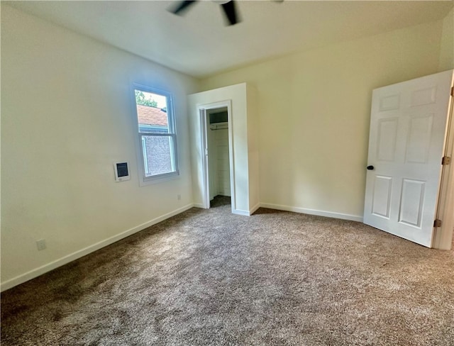 unfurnished bedroom featuring a closet, ceiling fan, and carpet floors