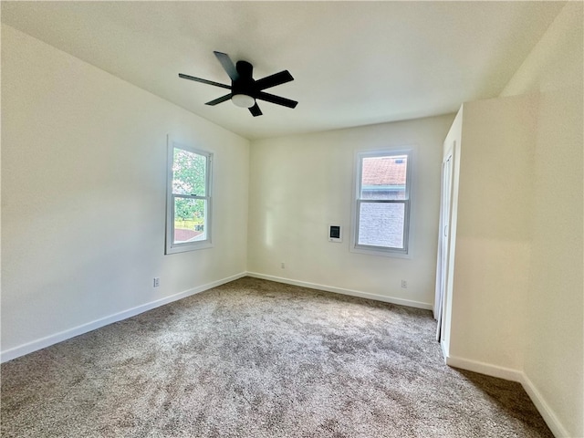 unfurnished room featuring ceiling fan and light carpet