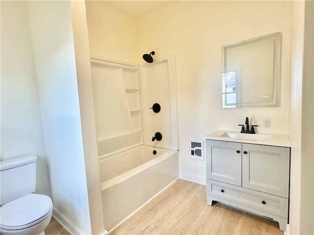 full bathroom with shower / tub combination, vanity, toilet, and hardwood / wood-style floors