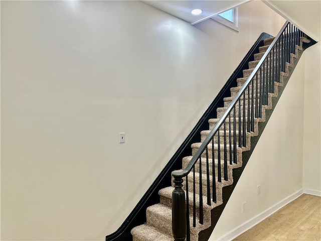 stairway with hardwood / wood-style floors