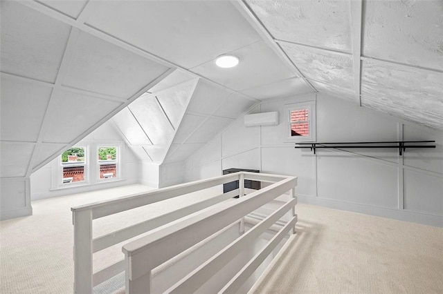 bonus room featuring a wall unit AC, lofted ceiling, and carpet