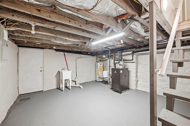 basement featuring water heater and sink