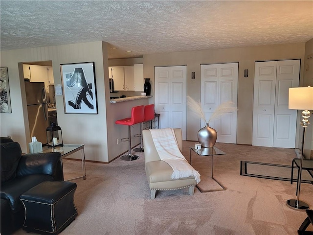 living room with a textured ceiling and light carpet