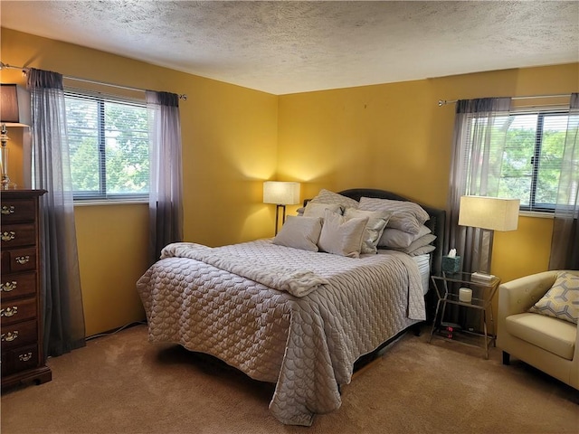 bedroom with a textured ceiling and carpet