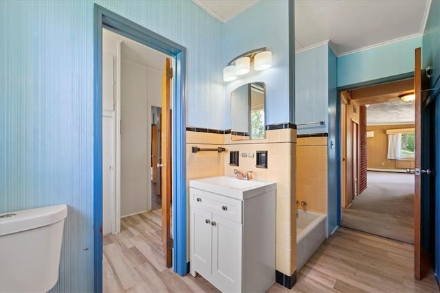 full bathroom featuring vanity, plenty of natural light, toilet, hardwood / wood-style flooring, and crown molding