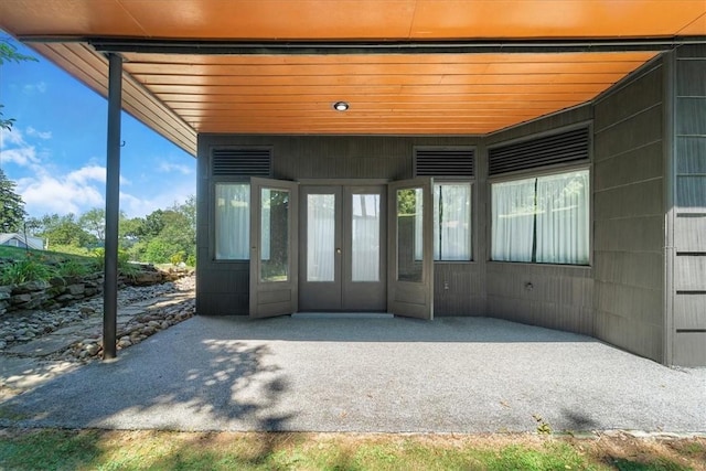 unfurnished sunroom with french doors