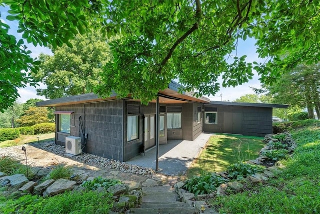 back of house with ac unit and a patio area