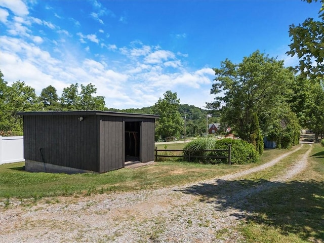 view of outbuilding featuring a lawn