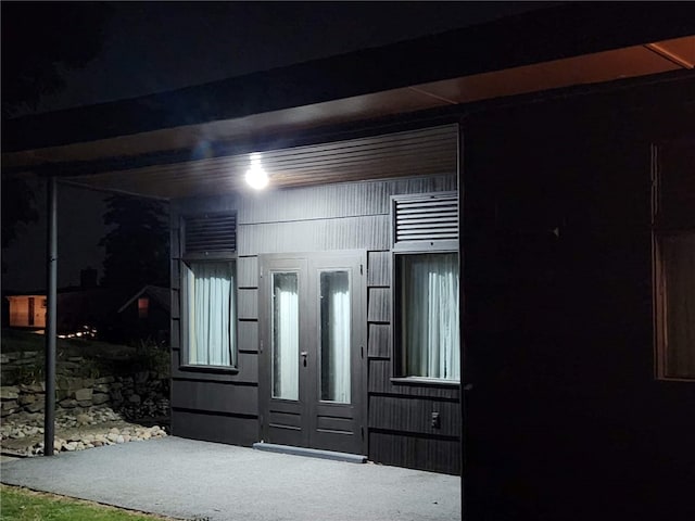 interior space featuring french doors and carpet flooring