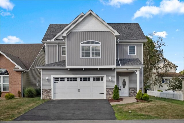 view of front of house featuring a garage and a front yard