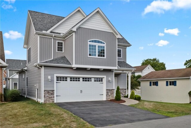 view of front facade featuring a garage and a front lawn