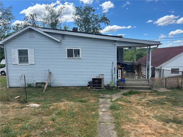 view of property exterior featuring central AC unit, a yard, and a deck