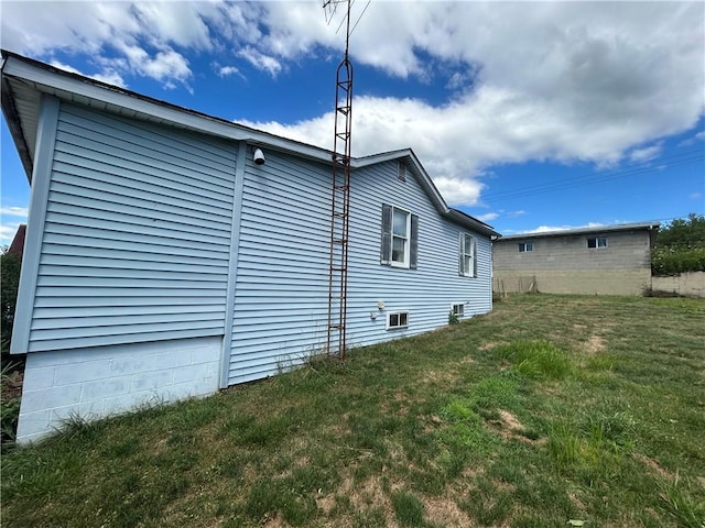 view of home's exterior with a lawn