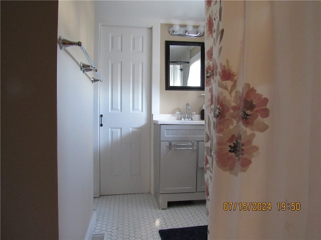 bathroom with tile patterned floors and vanity