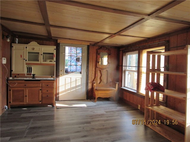 unfurnished room with hardwood / wood-style flooring, wood ceiling, wood walls, and beam ceiling