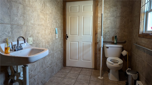 bathroom featuring tile walls, toilet, a baseboard radiator, and tile patterned floors